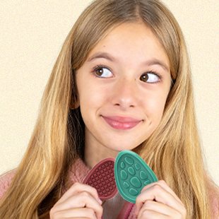 A girl holding KLT Morandi texture worry stones