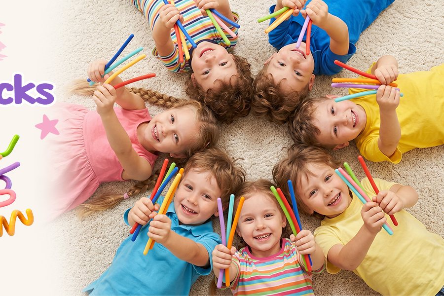 Kids lying in a circle holding KLT bendable fidget sticks